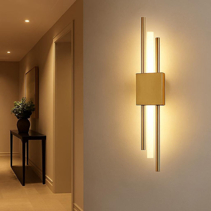 An artistic interior shot featuring the Lucas Wall Light Gold installed in a stylish hallway, with subtle shadows and warm white illumination creating a luxurious and modern atmosphere, complemented by elegant decor elements.