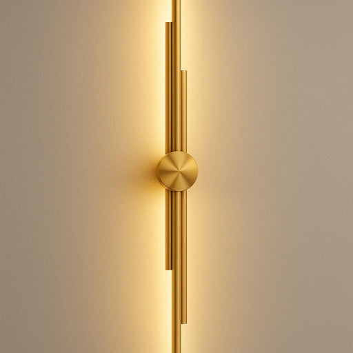 A close-up of the George Wall Light in matte gold, mounted on a modern living room wall with soft warm ambient lighting highlighting its sculptural design, in a well-lit contemporary interior.
