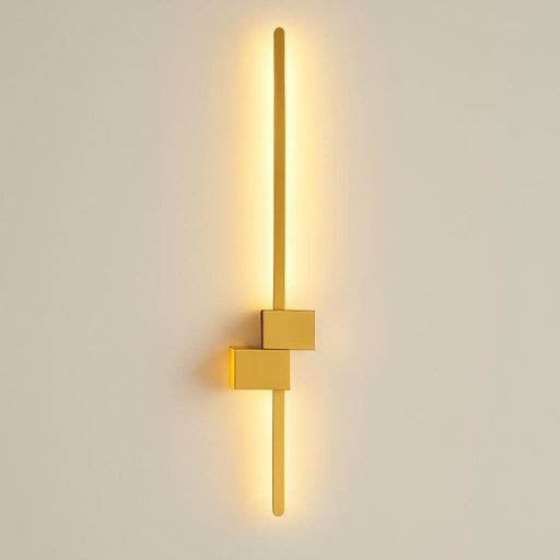 A studio shot capturing the entire length of the 90 cm Arlo Gold Wall Light against a neutral background, focusing on its durable aluminum construction, minimalist design, and subtle geometric details, illuminated softly to showcase the warm white light.