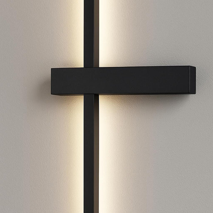 Close-up of the Dario LED wall light showcasing its matte black finish and architectural linear design, highlighting the high-quality aluminum material and the perpendicular element.